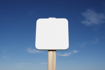 foreground of a square white  sign with blue skyの写真素材