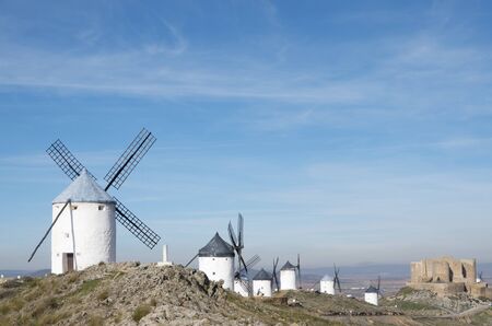 traditional windmills and castle in Consuegra, Toledo, Castilla La Mancha, Spainの写真素材