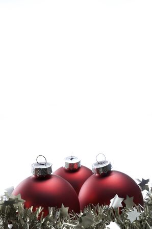 Christmas  decoration red balls and  tinsel with white backgroundの写真素材