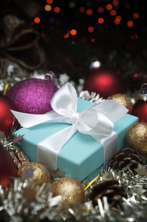 small turquoise box tied with a white ribbon and christmas decorationのeditorial素材