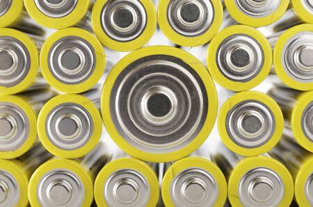 forefront of a group of yellow batteriesの写真素材