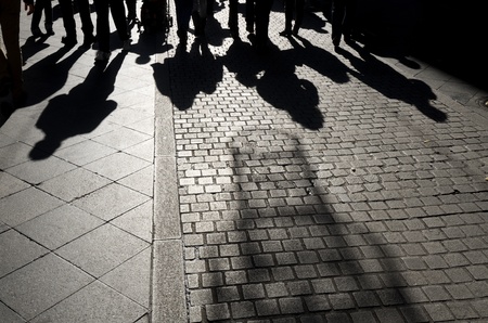 shadows of people walking along a  cobblestone street, Seville,  Andalucia, Spainの写真素材