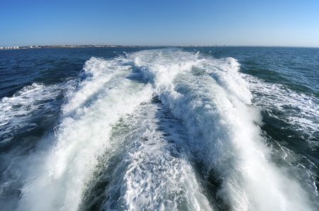 wake of a passenger ship in a clear sky dayの写真素材