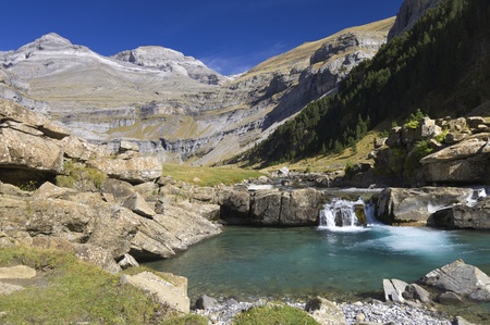 view of a waterfall and Monte Perdido peak in the valley of ordesa, Pyrenees, Huesca, Aragon, Spainの写真素材