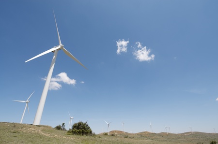 windmills for energy production and sky with white clouds