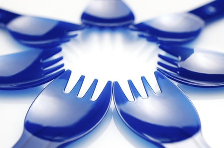 seven  disposable plastic forks on a white background