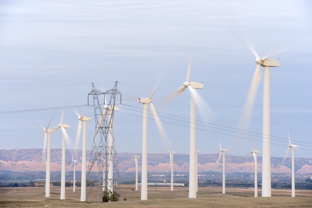 aligned windmills for renowable electric production and power line, Pozuelo de Aragon, Zaragoza,...