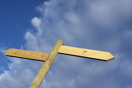 view of two wooden directional signs on a poleの写真素材