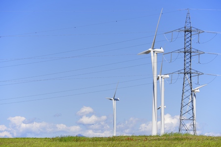 group of windmills for renewable electric energy production and pylon