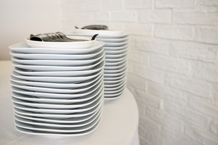group of white porcelain plates stackedの写真素材