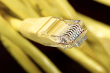 Yellow ethernet cable computer and black background