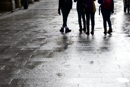 Walking along a cobblestone street, Old City Madrid, Spainの写真素材