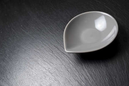 Small bowl to snack on a table slateの写真素材