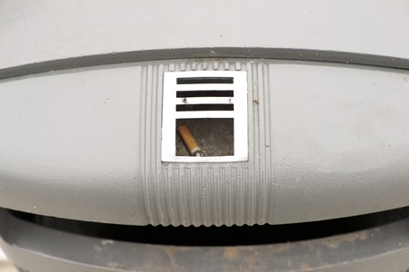 Cigarette in a public ashtray closeupの写真素材