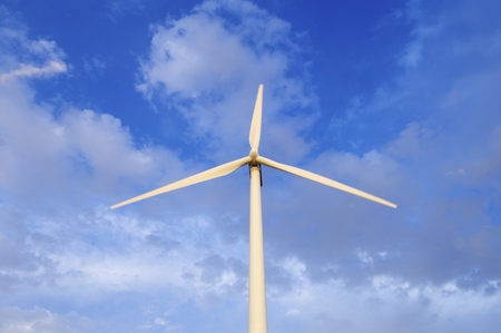 windmill for renewable electric energy production at sunset