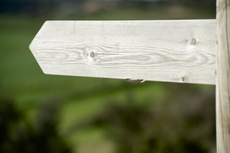 view of a wooden directional signs on a poleの写真素材
