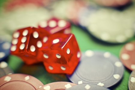 casino chips and dices stacking on a green feltの写真素材