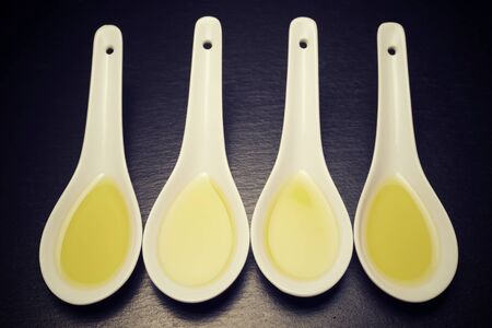 Olive oil in a small china spoons.の写真素材