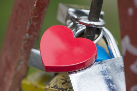 Love padlock on the railing of a bridgeの写真素材