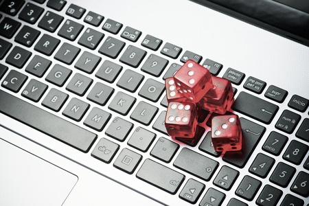 Dices group stacking on a laptopの写真素材