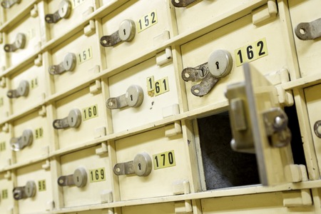 Closeup of a group of cells in an old safe bank.の写真素材