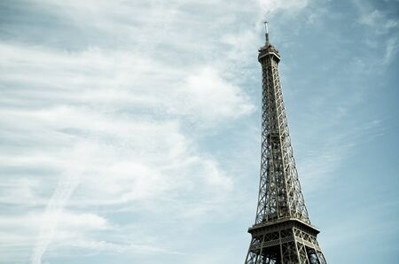 View of the Eiffel Tower with blue sky and white clouds, Paris, France