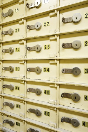 Closeup of a group of cells in an old safe bank.の写真素材