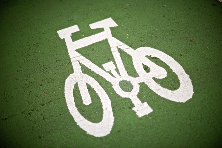 Bike lane sign painted on a street.
