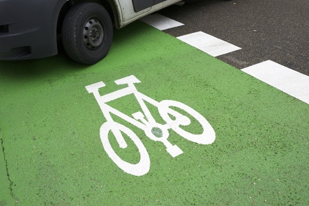 Bike lane sign painted on a street.