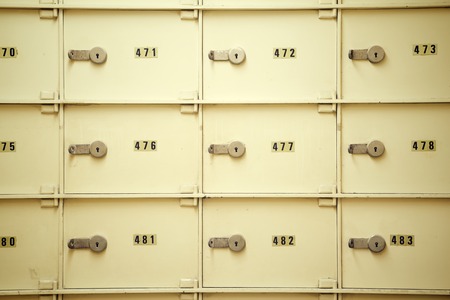 Closeup of a group of cells in an old safe bank.の写真素材
