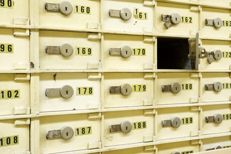 Closeup of a group of cells in an old safe bank.の写真素材