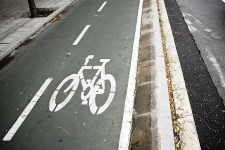 Bike lane sign painted on a street.の写真素材