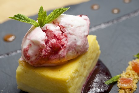Cheesecake with red fruit and ice cream.の写真素材