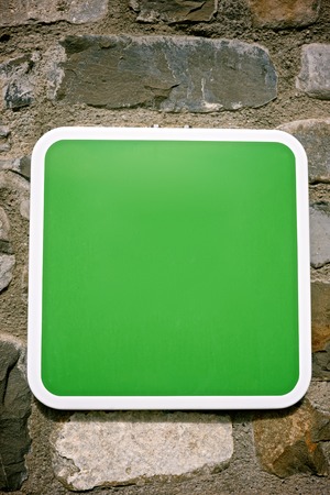 Green signal on a stone wall.の写真素材