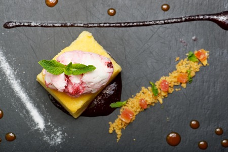 Cheesecake with red fruit and ice cream.の写真素材