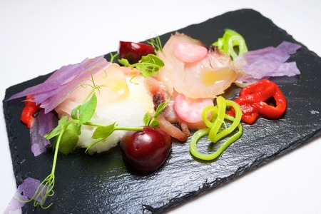 Tuna salad with almond cream served on a tray slate.