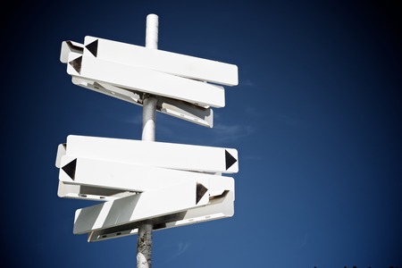 Directional signals in a pole with blue skyの写真素材