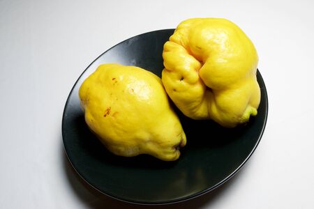 Quince pieces in a black bowl.の写真素材