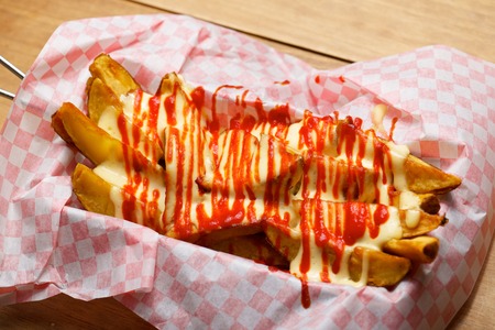 Potatoes with spicy sauce on a checkered paper.の写真素材