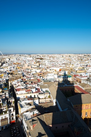 Aerial view of Old Seville from the Giralda Tower, to the right is the shadow of the tower itself, Andalucia, Spain.の写真素材