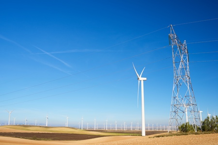 Windmills for electric power production and pylon, Zaragoza Province, Aragon, Spain.