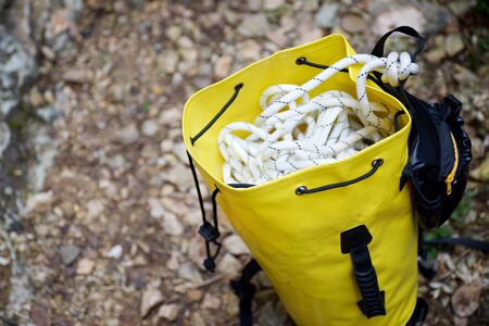Climbing rope inside a yellow backpack.