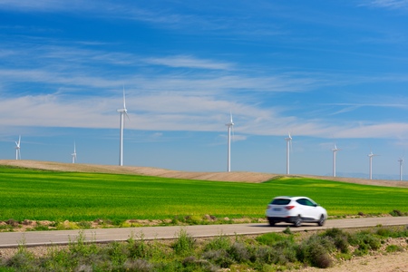 Windmills for electric power production and car, Zaragoza province, Aragon, Spain.の写真素材