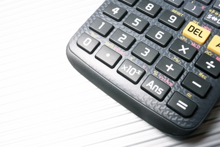 Scientific calculator close up on a metal table.