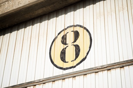 Number eight on a metal blind.