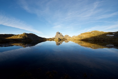 Midi Dossau Peak reflected in a lake. Ossau Valley, Pyrenees National Park, Pyrenees, France.の写真素材