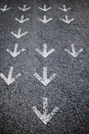 Directional arrows painted on a cement floor.の写真素材