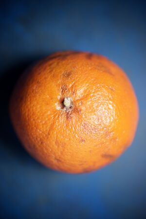 Close-up of an orange on a blue background.の写真素材