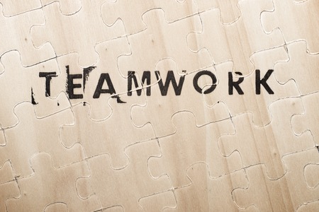 Teamwork word stamped on a wooden puzzle.の写真素材