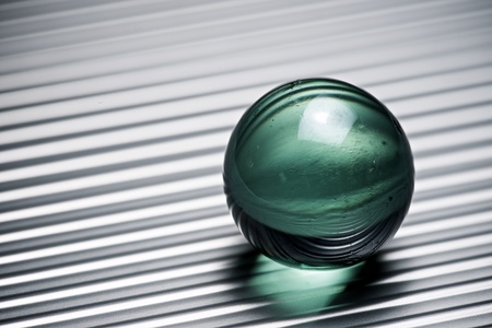 Glass ball on a metallic table.の写真素材